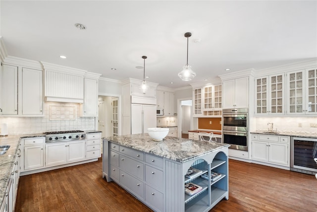 32 Pryer Ln, Larchmont, NY 10538 - kitchen featuring white cabinets, appliances with stainless steel finishes, decorative backsplash, and wine cooler