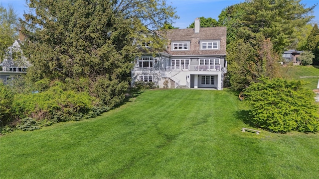 32 Pryer Ln, Larchmont, NY 10538 - rear view of property featuring a deck, french doors, a chimney, stairs, and a lawn