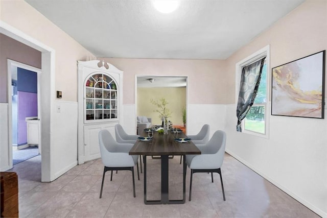 66-68 Spook Hole Rd, Ellenville, NY 12428 - dining space with wainscoting and light tile patterned flooring