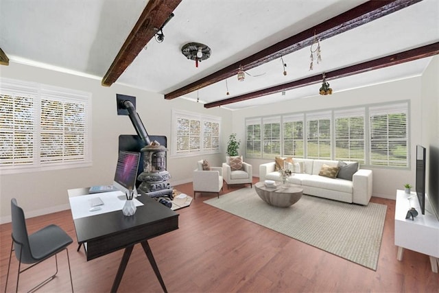 66-68 Spook Hole Rd, Ellenville, NY 12428 - living room with wood finished floors, a wood stove, beamed ceiling, and a healthy amount of sunlight