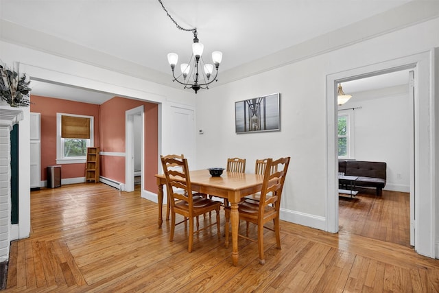 155 Tuckers Corners Rd, Plattekill, NY 12528 - dining space featuring a baseboard heating unit, a chandelier, and light wood finished floors