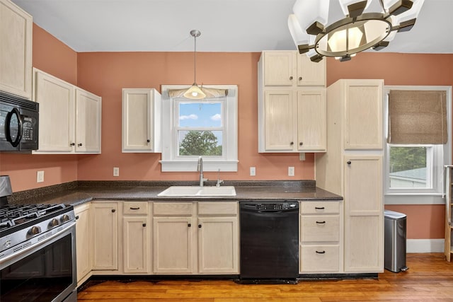 155 Tuckers Corners Rd, Plattekill, NY 12528 - kitchen with black appliances, dark countertops, light wood-style flooring, and hanging light fixtures