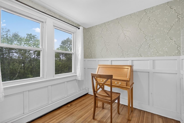 155 Tuckers Corners Rd, Plattekill, NY 12528 - dining room featuring a baseboard radiator, wallpapered walls, a decorative wall, a wainscoted wall, and light wood-type flooring