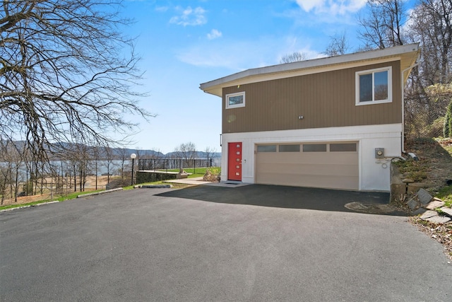 view of property exterior with aphalt driveway
