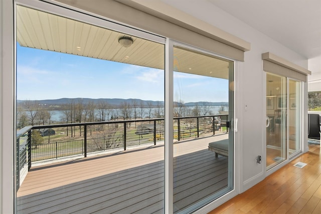 entryway featuring a mountain view, visible vents, and hardwood / wood-style flooring