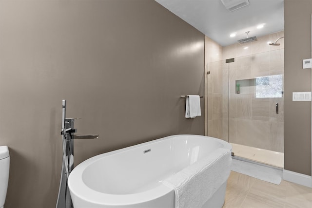 full bath with a freestanding bath, a shower stall, tile patterned flooring, and visible vents