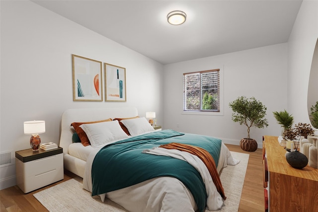 bedroom featuring light wood-type flooring and baseboards