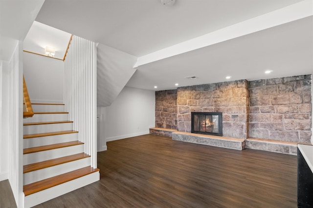 unfurnished living room with a fireplace, recessed lighting, wood finished floors, stairs, and baseboards