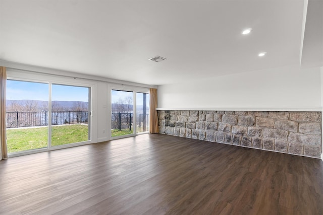 unfurnished room featuring dark wood-type flooring and visible vents