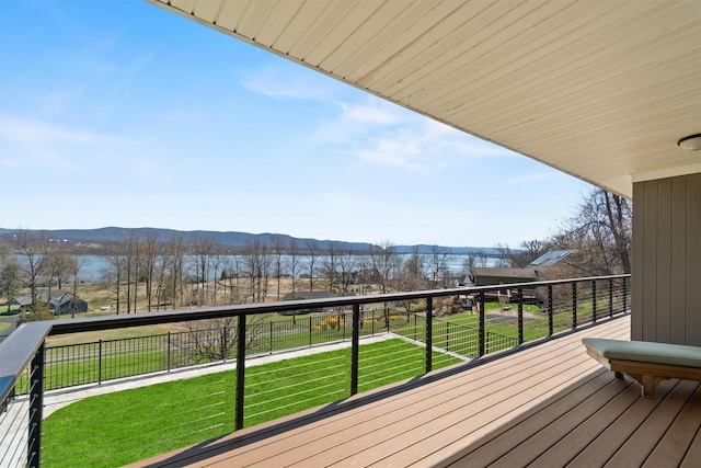 deck with a mountain view and a lawn
