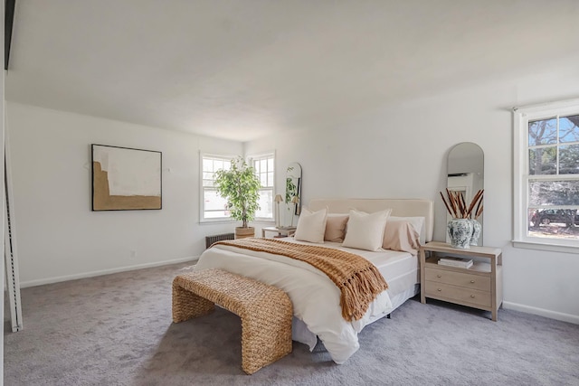 bedroom featuring multiple windows, radiator, and light colored carpet