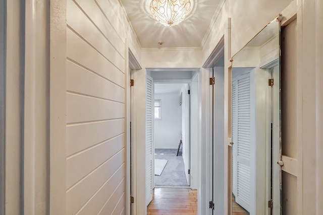 hall featuring light wood-style flooring and ornamental molding