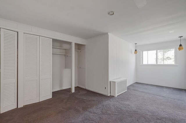unfurnished bedroom featuring carpet flooring and a closet