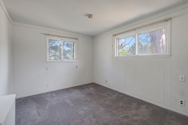 carpeted spare room with baseboards