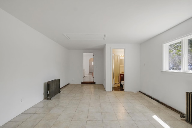 unfurnished room featuring radiator
