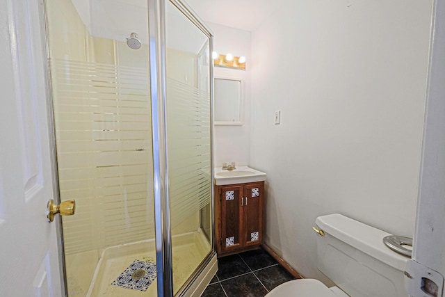 bathroom featuring tile patterned floors, toilet, vanity, and a stall shower