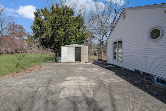 view of patio / terrace with an outbuilding and a shed