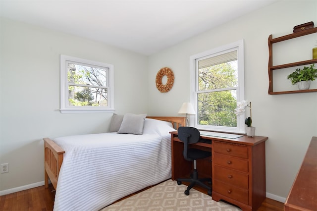 bedroom featuring light wood-type flooring and baseboards