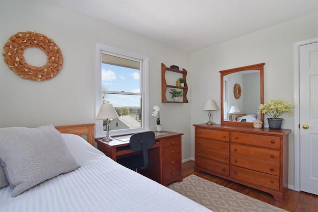 bedroom featuring baseboards and wood finished floors