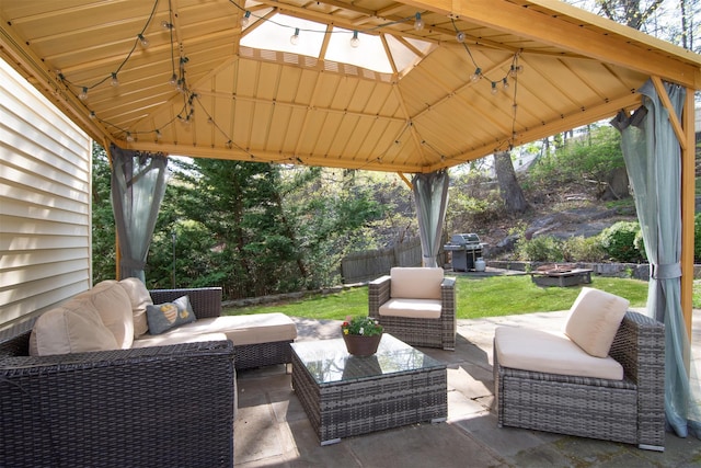 view of patio with fence, a gazebo, grilling area, and an outdoor hangout area