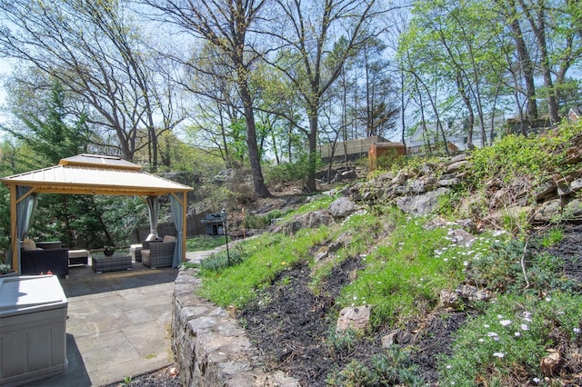 view of yard featuring a patio, an outdoor hangout area, and a gazebo