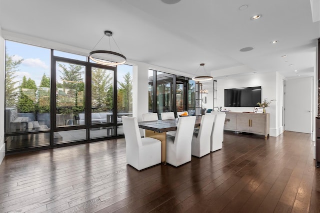 dining space with dark wood-style flooring, a wall of windows, and recessed lighting