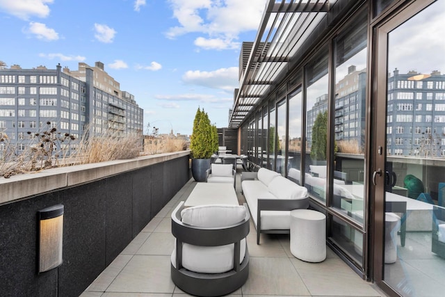 balcony with a view of city and an outdoor hangout area