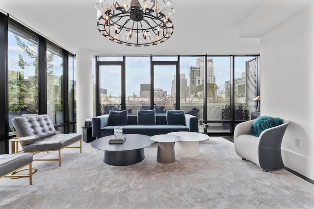 living room with a city view, an inviting chandelier, and floor to ceiling windows