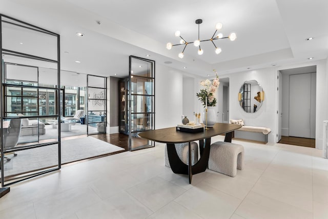 dining area with an inviting chandelier, expansive windows, recessed lighting, light tile patterned flooring, and a raised ceiling