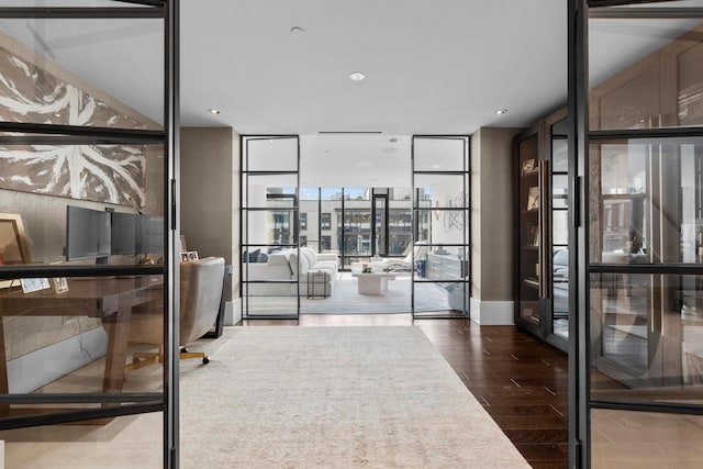 office space with expansive windows and wood finished floors