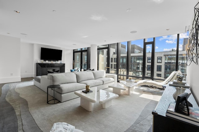 living room with baseboards and a wall of windows