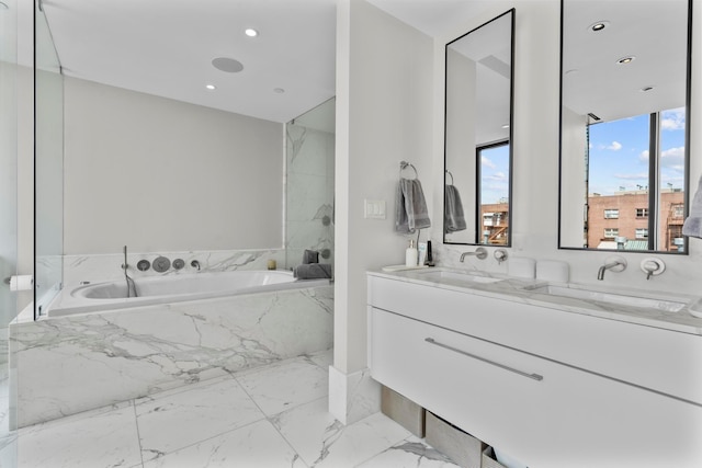 full bathroom featuring a sink, a bath, double vanity, and marble finish floor