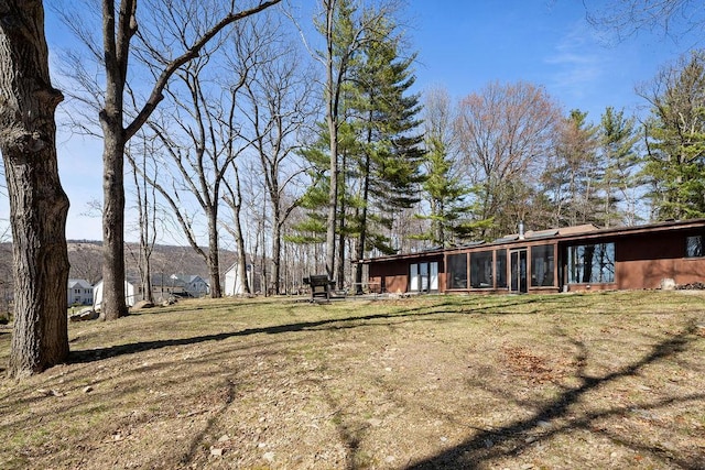 view of yard with a sunroom