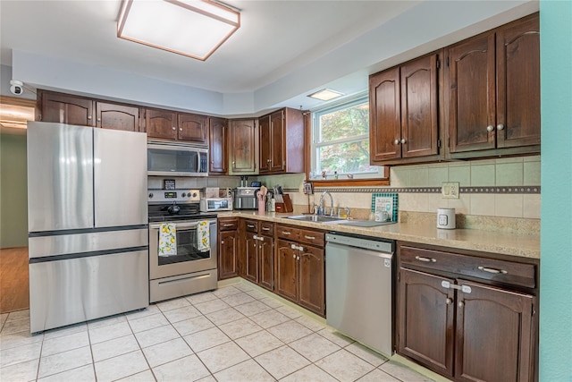 6 Swain Dr, Pleasant Valley, NY 12569 - kitchen featuring appliances with stainless steel finishes, a sink, light tile patterned flooring, light countertops, and dark brown cabinetry