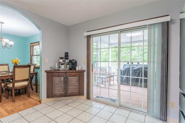 6 Swain Dr, Pleasant Valley, NY 12569 - dining space with arched walkways, plenty of natural light, light tile patterned flooring, and a chandelier