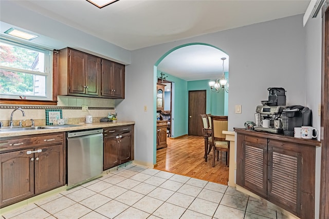 6 Swain Dr, Pleasant Valley, NY 12569 - kitchen with dishwasher, a sink, arched walkways, light countertops, and light tile patterned flooring