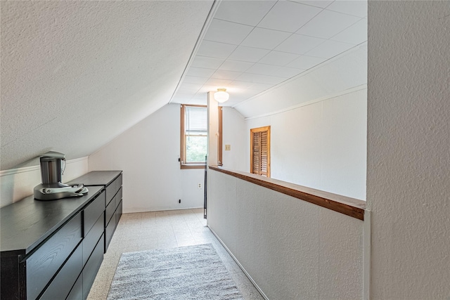 6 Swain Dr, Pleasant Valley, NY 12569 - corridor featuring vaulted ceiling, a textured wall, and baseboards