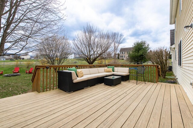 wooden deck with an outdoor hangout area and a yard