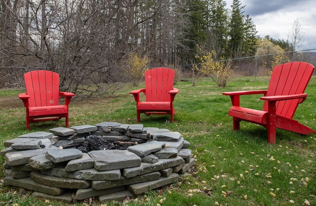 view of yard with fence and a fire pit