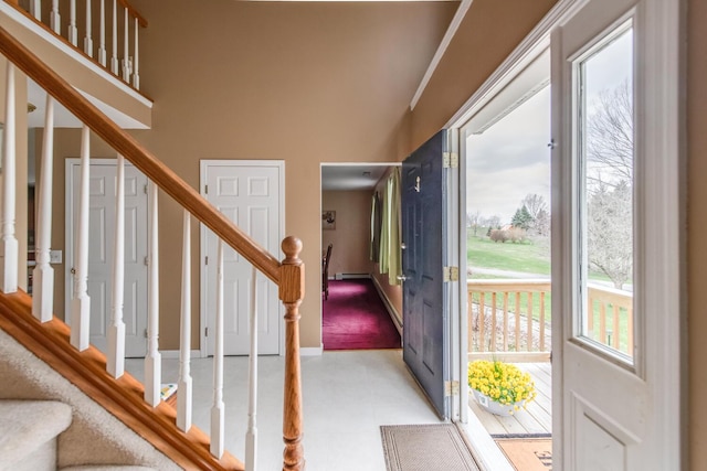 foyer entrance featuring baseboards, light floors, and stairway