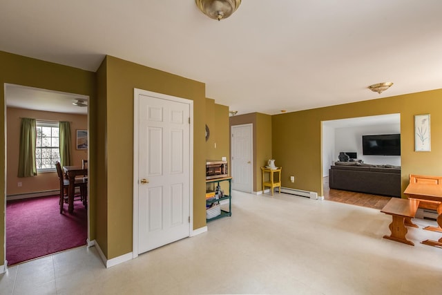 interior space with baseboards, a baseboard radiator, a baseboard heating unit, and light colored carpet