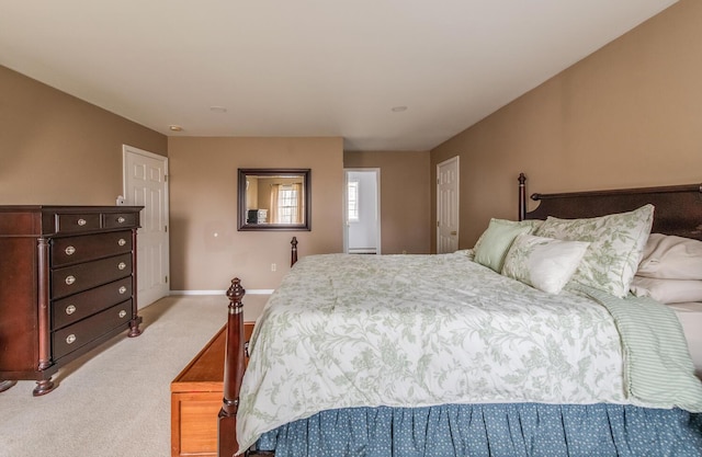 bedroom featuring baseboards and light colored carpet
