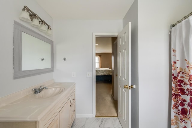 bathroom featuring vanity, marble finish floor, and ensuite bath
