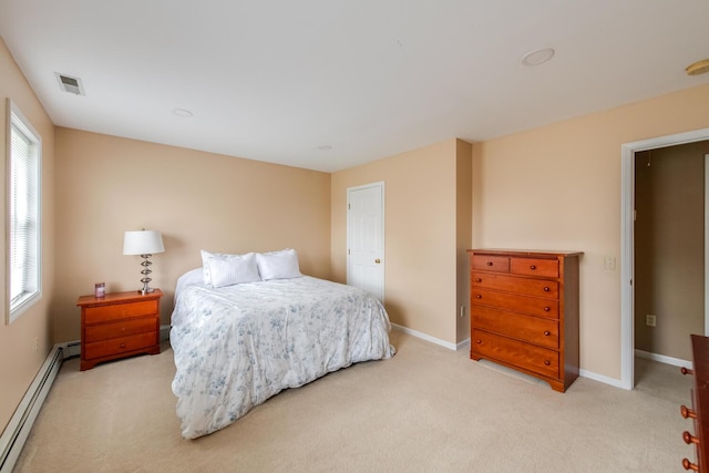 bedroom with a baseboard heating unit, light colored carpet, visible vents, and baseboards