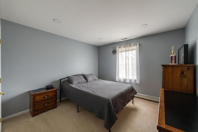 bedroom featuring light colored carpet, baseboards, a baseboard heating unit, and visible vents