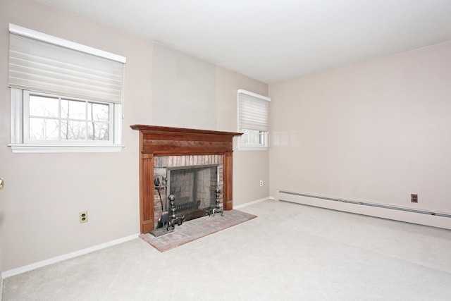 unfurnished living room featuring carpet, a baseboard radiator, a fireplace with raised hearth, and plenty of natural light