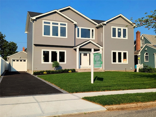 1135 Logan Rd, Wantagh, NY 11793 - view of front of property with an outbuilding, driveway, board and batten siding, and a garage