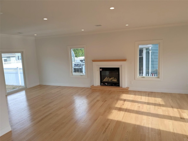 1135 Logan Rd, Wantagh, NY 11793 - unfurnished living room featuring crown molding, a glass covered fireplace, wood finished floors, baseboards, and recessed lighting