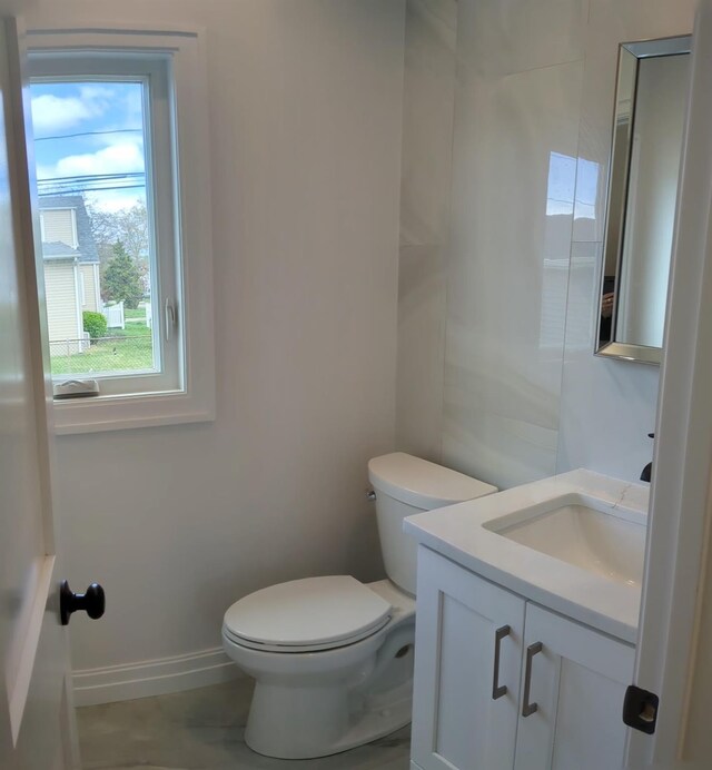 1135 Logan Rd, Wantagh, NY 11793 - bathroom with toilet, vanity, and baseboards