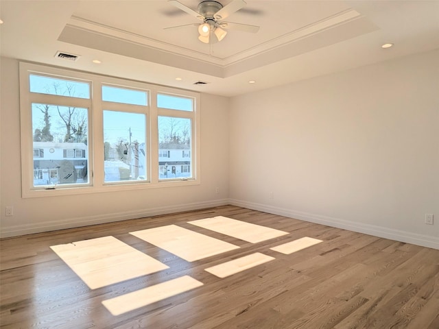 1135 Logan Rd, Wantagh, NY 11793 - unfurnished room featuring a tray ceiling, crown molding, wood finished floors, ceiling fan, and baseboards